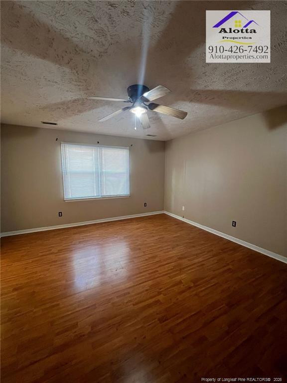 732 Rim Road Fayetteville, NC 28314 - Photo 6 of 17 an empty room with wooden floor and windows
