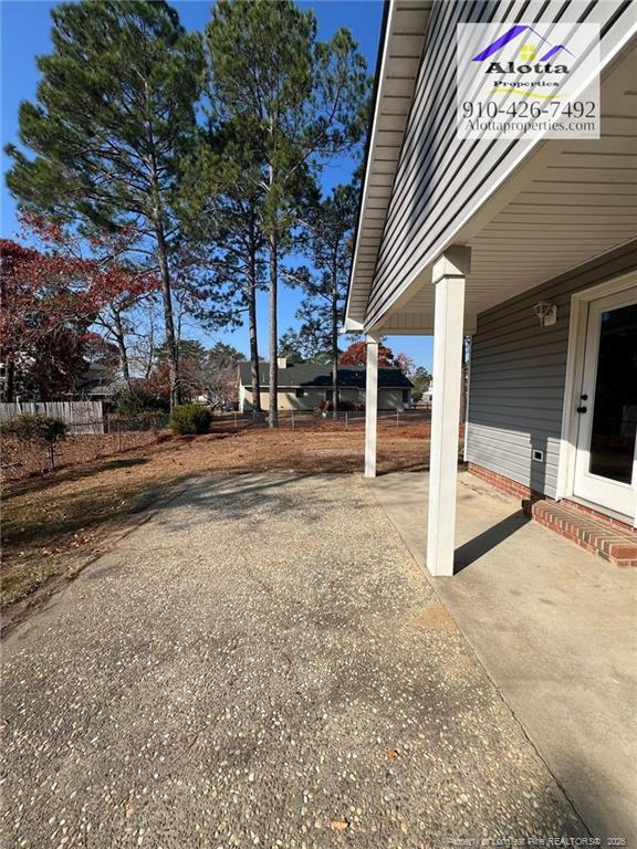 732 Rim Road Fayetteville, NC 28314 - Photo 7 of 17 a view of a house with a tree next to a road