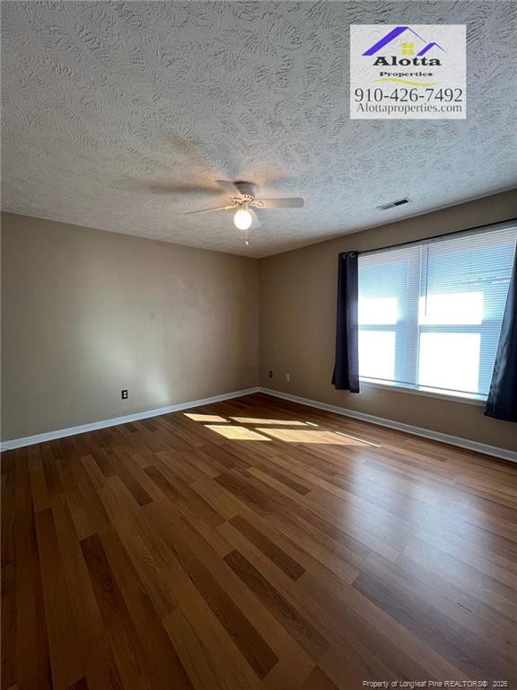 732 Rim Road Fayetteville, NC 28314 - Photo 10 of 17 an empty room with wooden floor and windows