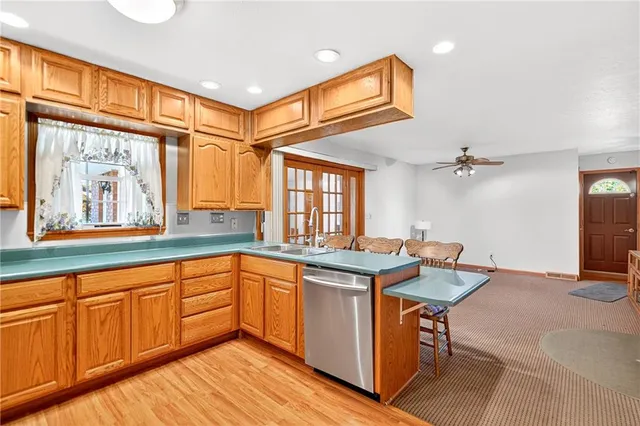 a kitchen with stainless steel appliances granite countertop a sink and cabinets