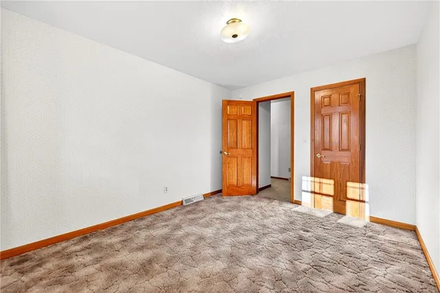 a view of a room with wooden floor and a window