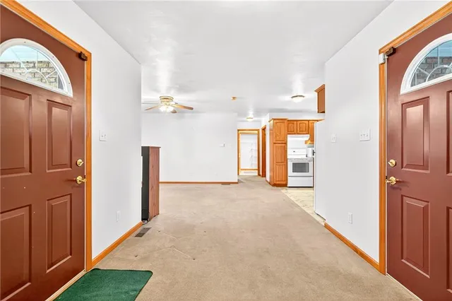 a view of an empty room with a refrigerator
