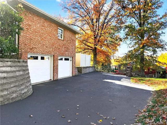 a view of a house with a large tree