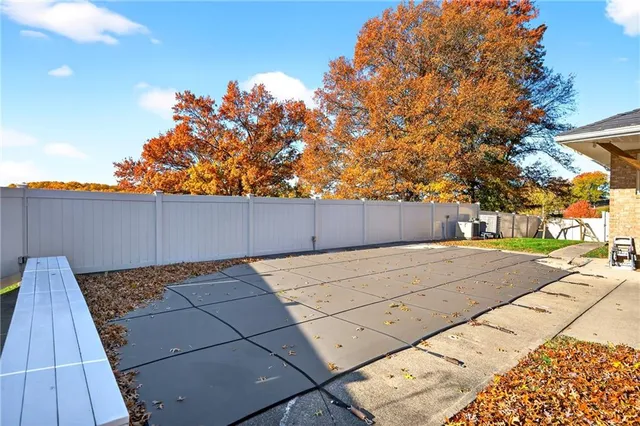 a backyard of a house with table and chairs