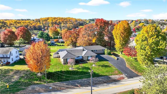 a aerial view of a house with a garden and trees