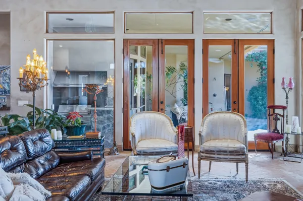 a living room with furniture and a chandelier