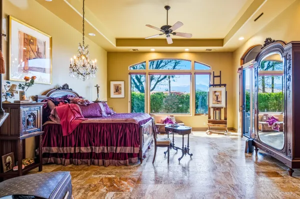 a living room with furniture a chandelier and a large window