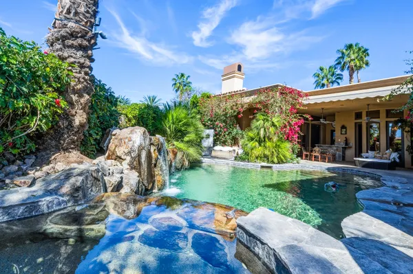 a view of backyard with outdoor seating and green space