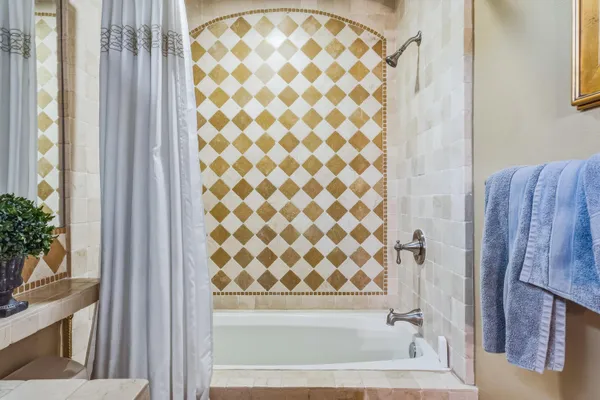 a bathroom with a bathtub and shower