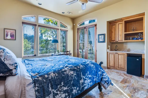 a bed sitting in a spacious bedroom next to a window