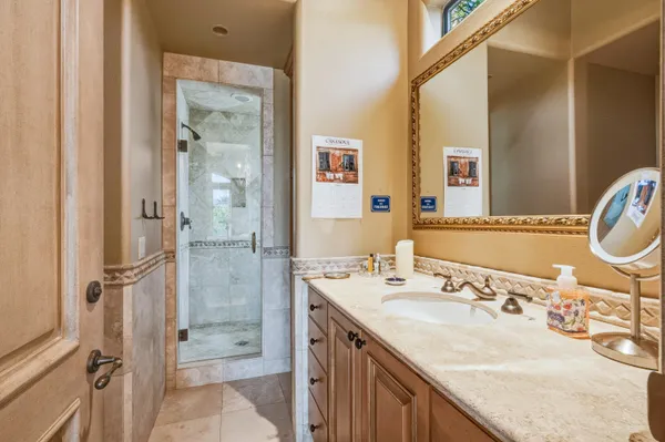 a bathroom with a granite countertop sink and a mirror
