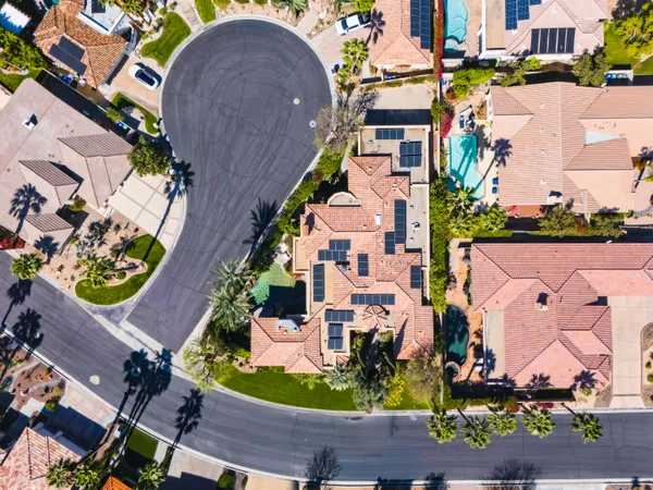 an aerial view of a house with a swimming pool