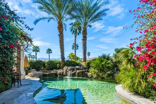 a view of a lake with a bench in a garden