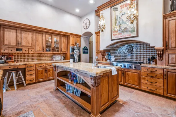 a very nice looking kitchen with stainless steel appliances granite countertop a stove and a cabinets