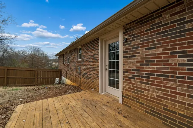 a view of house with wooden floor and a floor to ceiling window