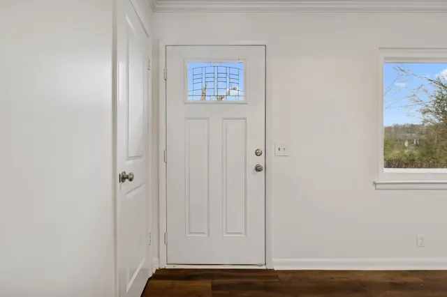 a view of front door with wooden floor