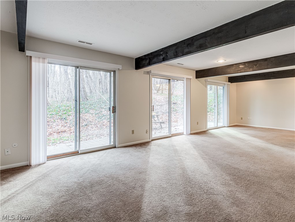 2550 Chamberlain Road, Unit A3 Akron, OH 44333 - Photo 7 of 21 Living room with beam ceiling and light carpet