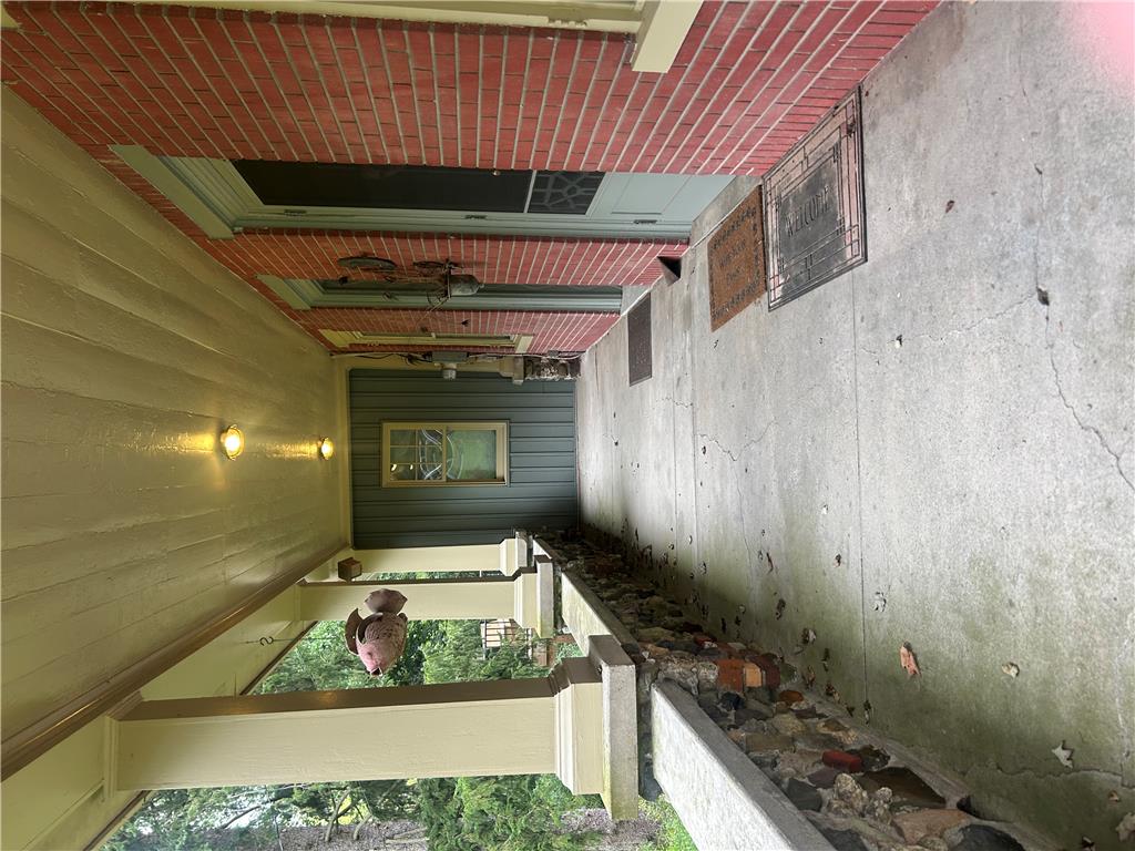 7 Allegheny Road Mount Bethel, PA 18343 - Photo 3 of 71 Craftsman details frame a concrete covered porch with exposed brick and stone accents.