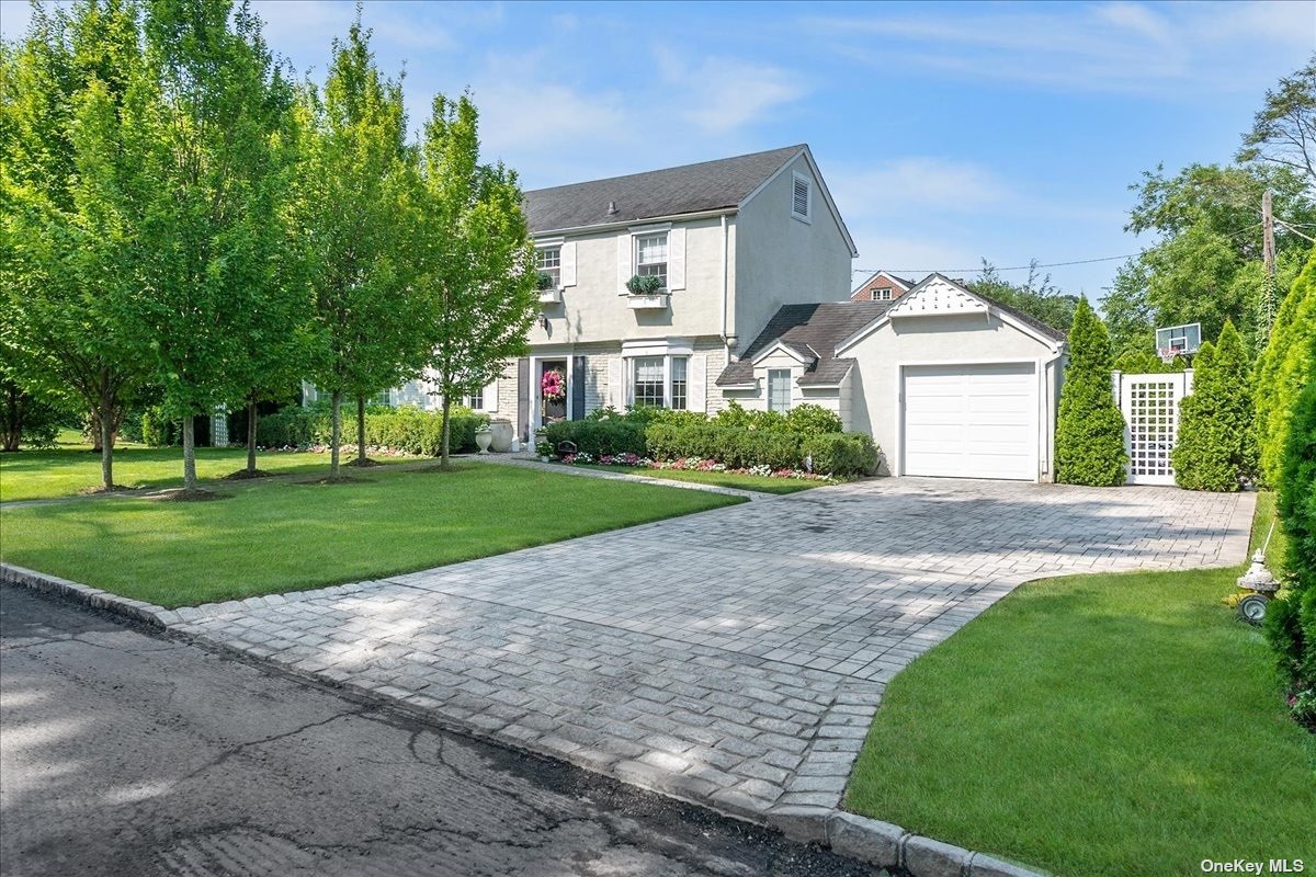 33 Pickwick Road Manhasset, NY 11030 - Photo 1 of 1 a front view of a house with a yard