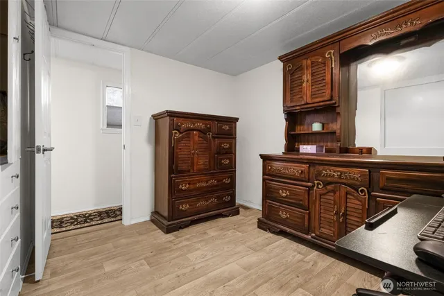 a backyard of a house with wooden deck and outdoor seating