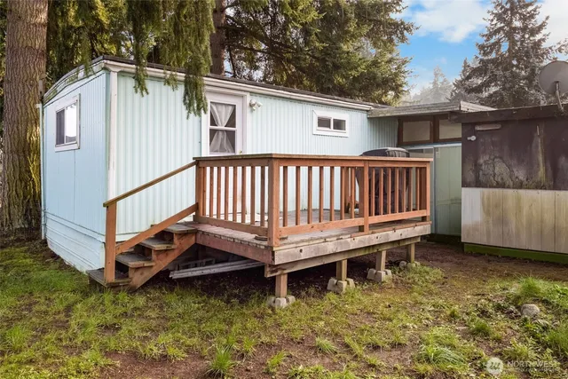 a view of a house with backyard and sitting area
