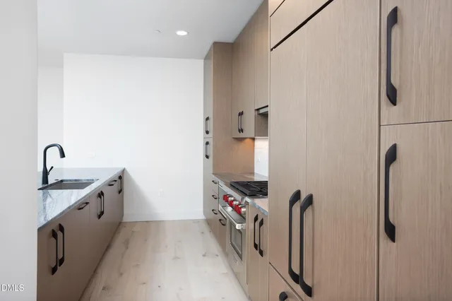 a kitchen with stainless steel appliances granite countertop a refrigerator and a sink