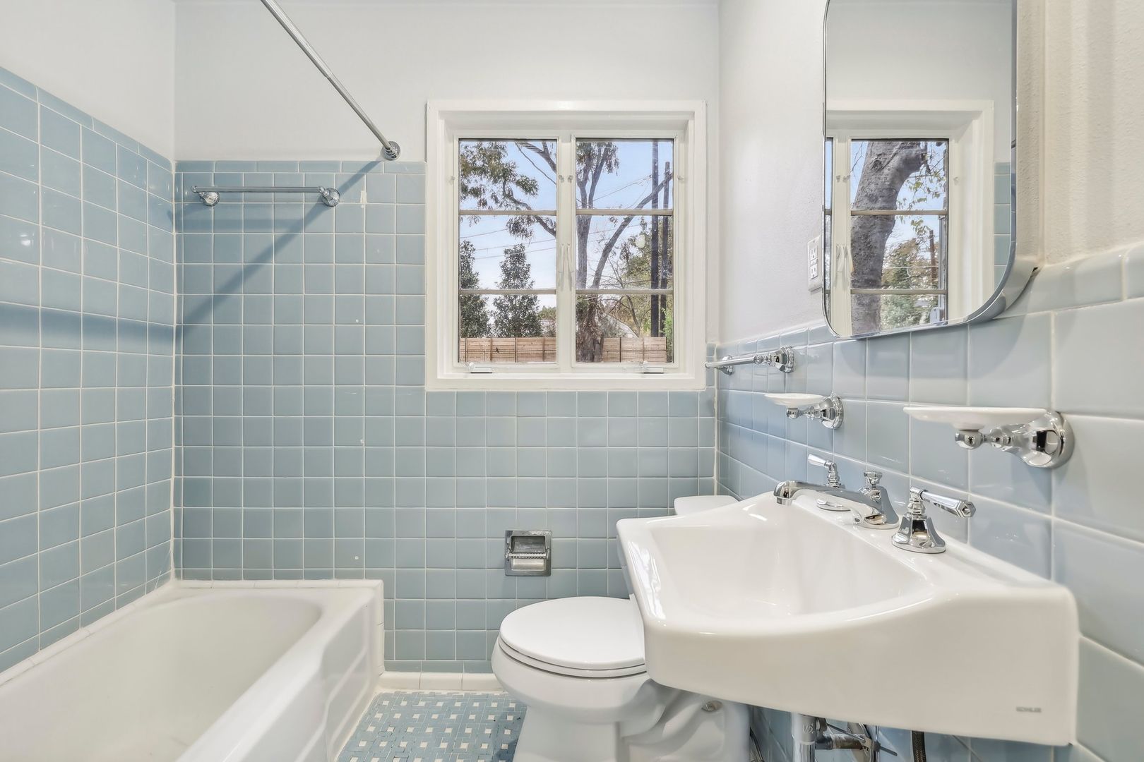 3010 Windsor Road, Unit E Austin, TX 78703 - Photo 15 of 17 a bathroom with a sink a mirror a toilet and a bathtub