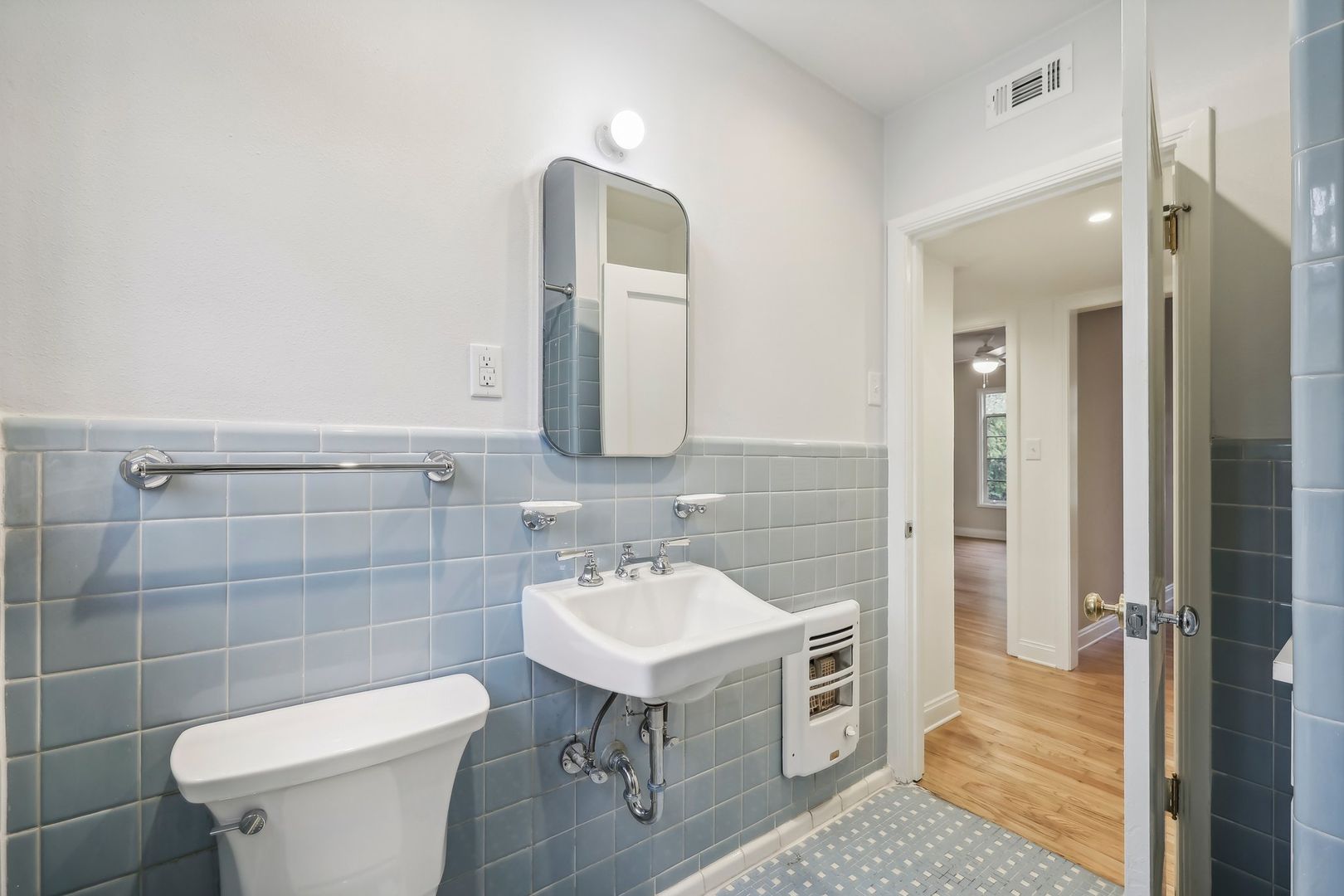 3010 Windsor Road, Unit E Austin, TX 78703 - Photo 16 of 17 a bathroom with a toilet sink and mirror