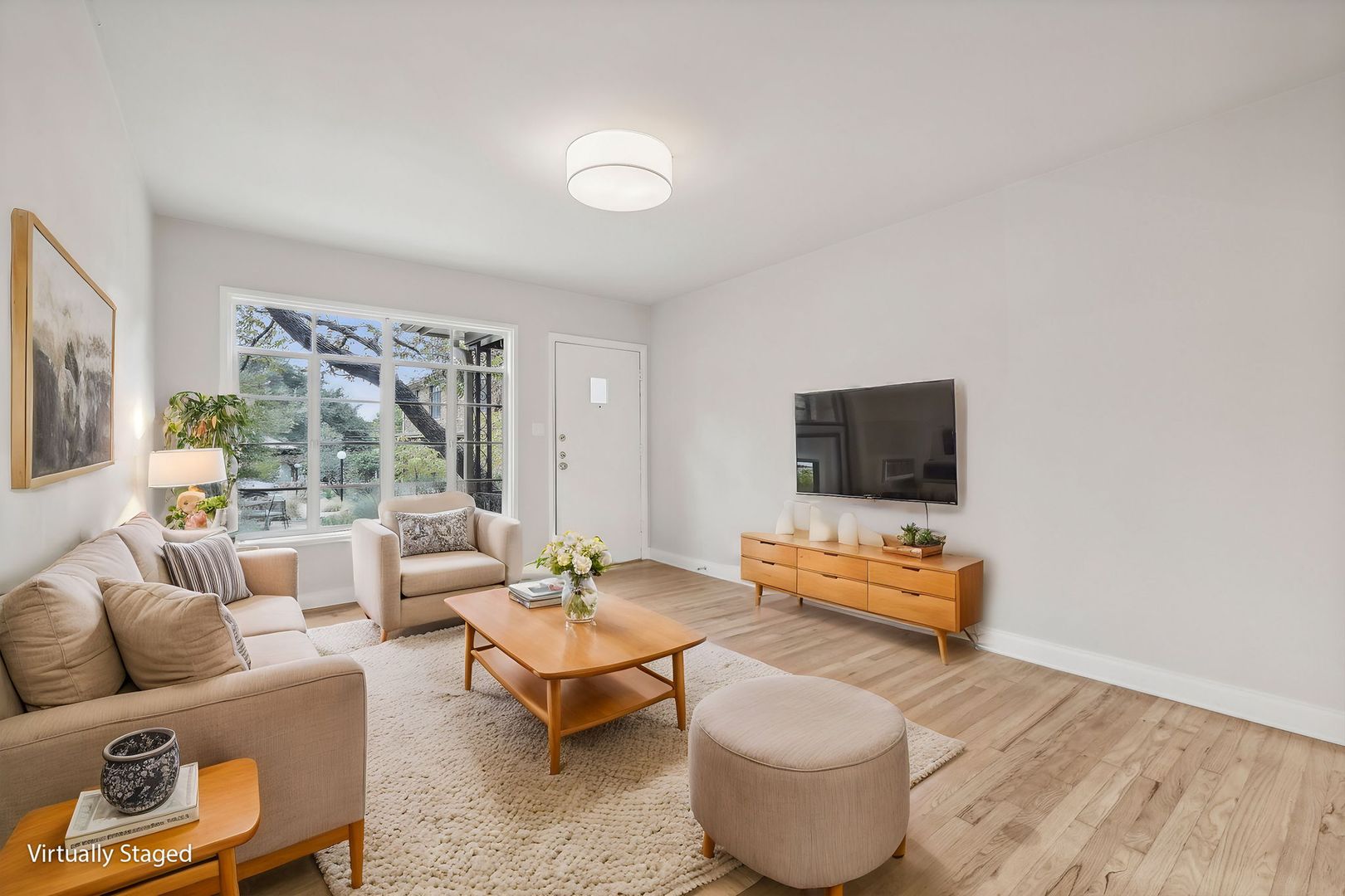 3010 Windsor Road, Unit E Austin, TX 78703 - Photo 2 of 17 a living room with furniture and a flat screen tv