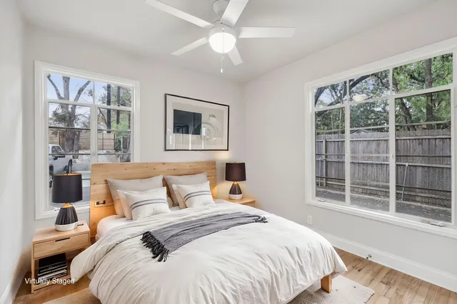 a bedroom with a large bed and a large window