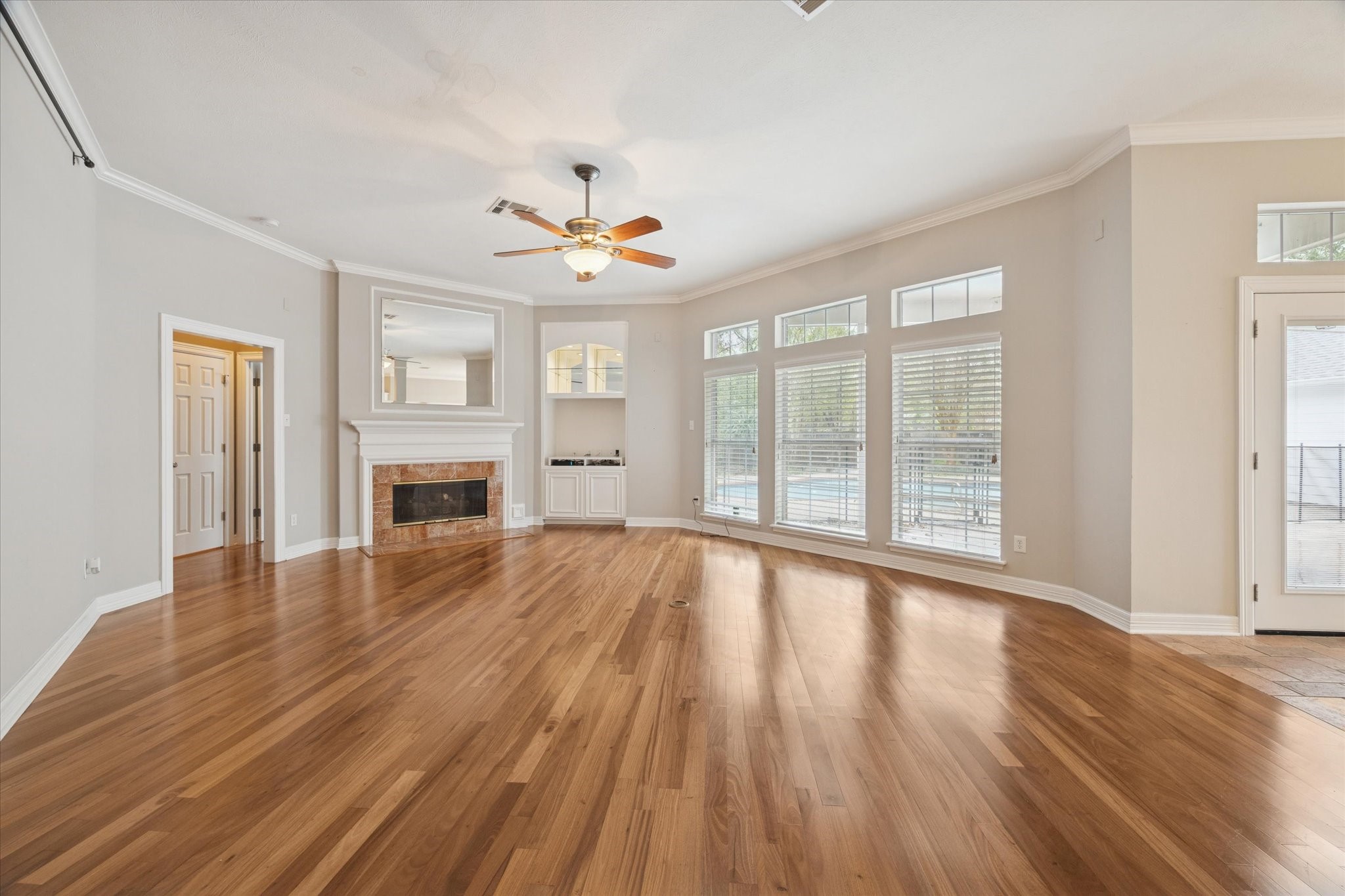 304 Scenic View Friendswood, TX 77546 - Photo 12 of 41 a view of an empty room with wooden floor and a window