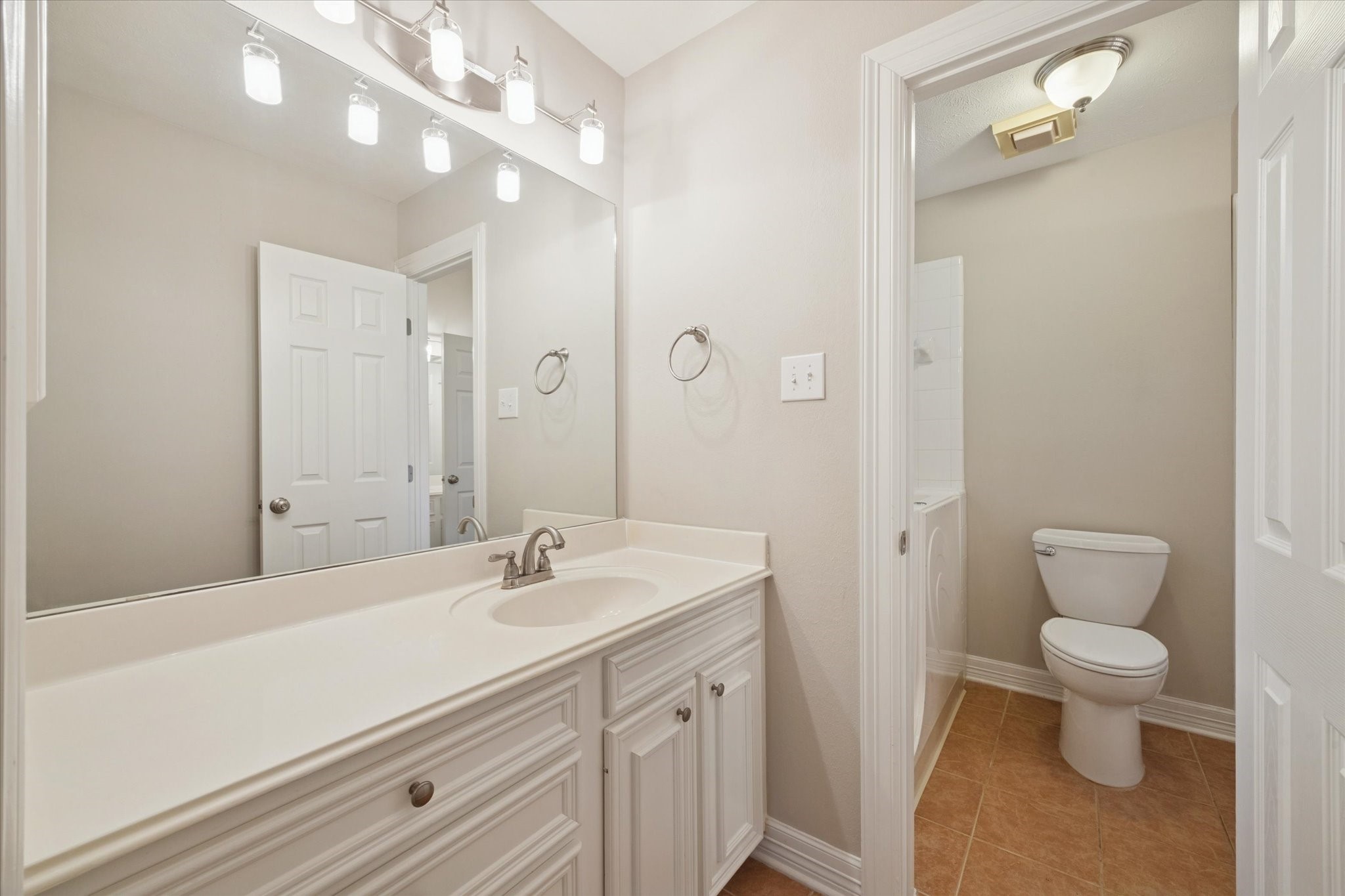 304 Scenic View Friendswood, TX 77546 - Photo 23 of 41 a bathroom with a sink a toilet and a mirror