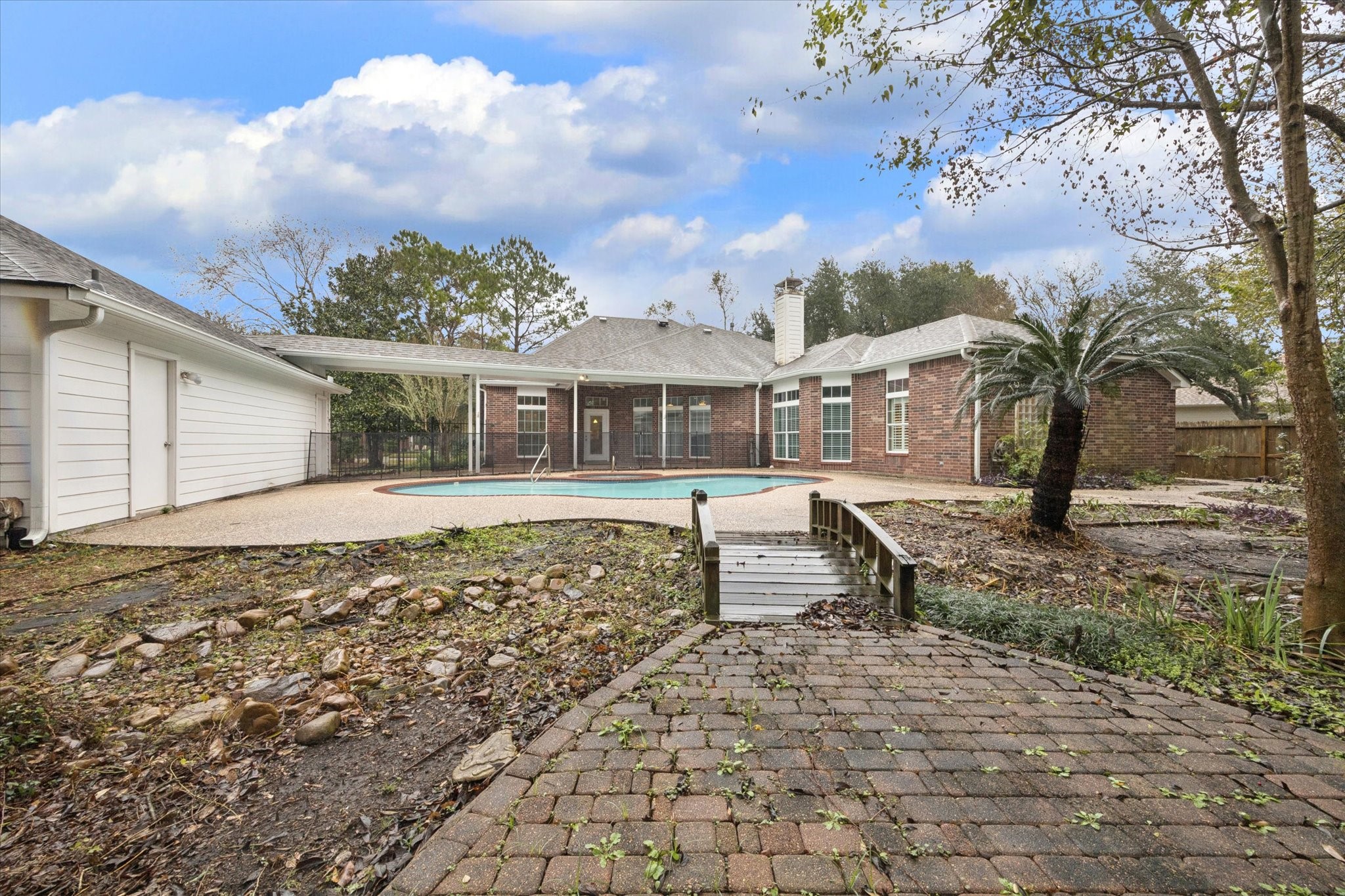 304 Scenic View Friendswood, TX 77546 - Photo 39 of 41 This backyard is absolutely GORGEOUS in the spring and summer!! Even has a riverbed stream and two quaint bridges. A GARDENER'S DREAM!