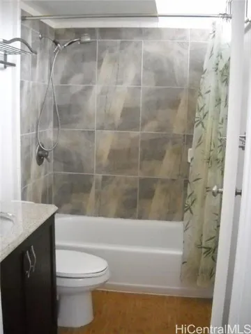 a bathroom with a sink vanity and toilet