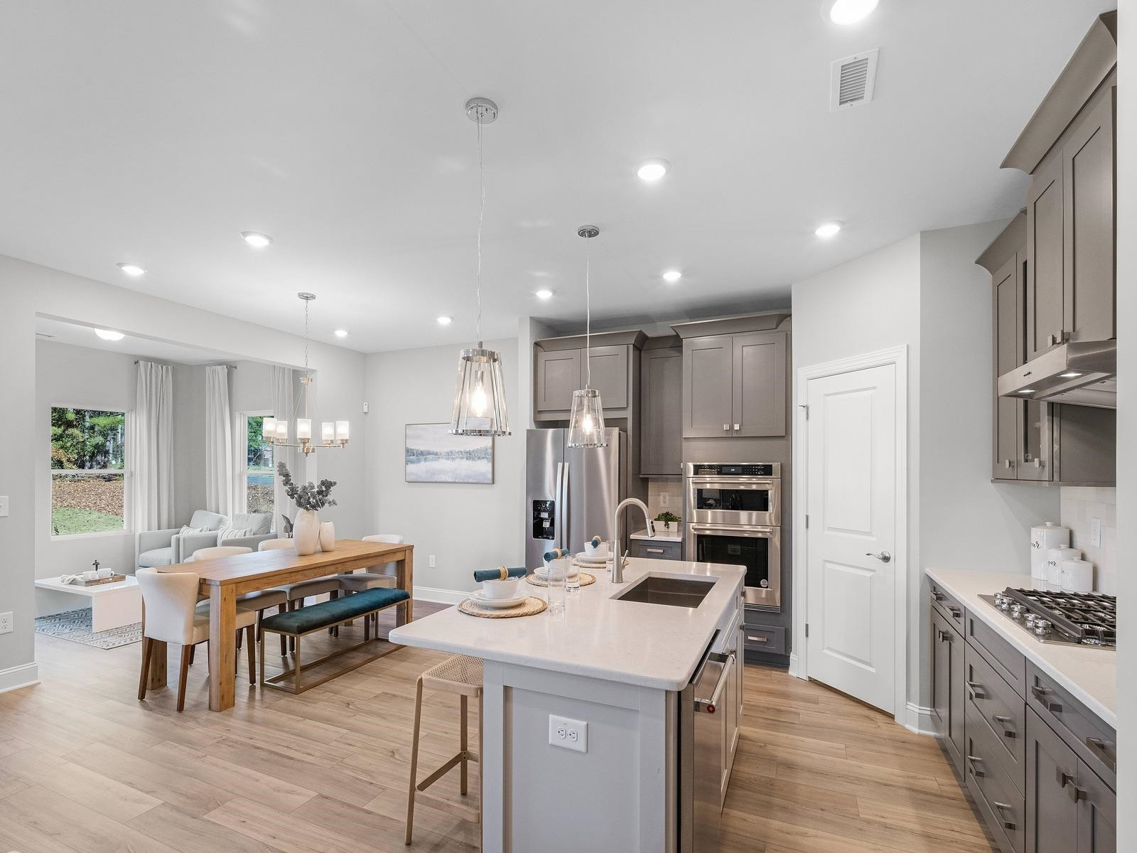 8317 Aldous Way Raleigh, NC 27616 - Photo 2 of 16 a kitchen with stainless steel appliances kitchen island granite countertop a stove a sink a refrigerator and a refrigerator