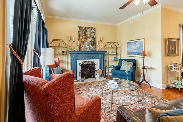 a living room with furniture a rug and a fireplace