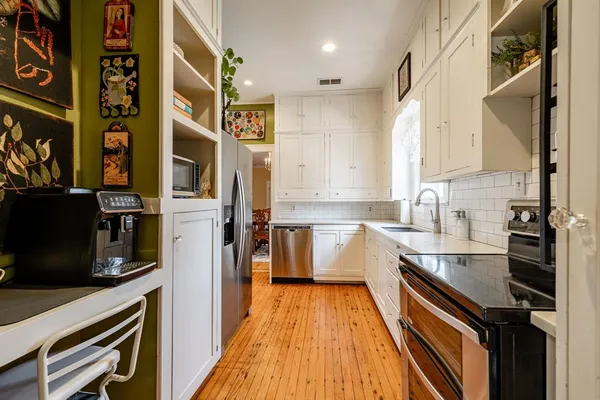 a kitchen with stainless steel appliances a sink and cabinets