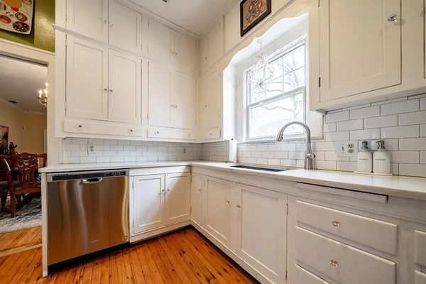 a kitchen with appliances cabinets and a window