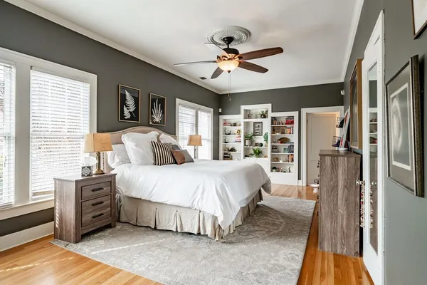 a spacious bedroom with a large bed and a chandelier