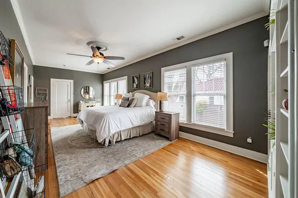 a spacious bedroom with a bed and a large window
