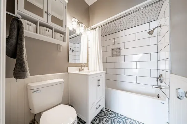 a bathroom with a toilet a sink and bathtub