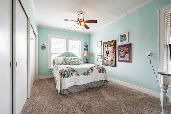 a bedroom with a bed and window