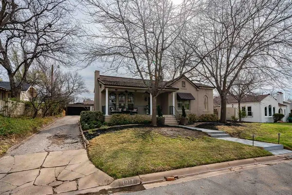 a front view of house with yard and trees around