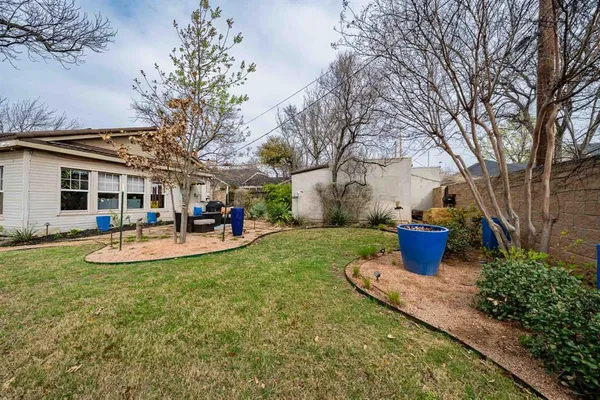a view of a house with backyard porch and sitting area