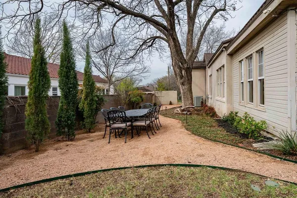a view of a house with backyard and sitting area
