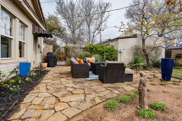 a view of a patio with a table and chairs and potted plants