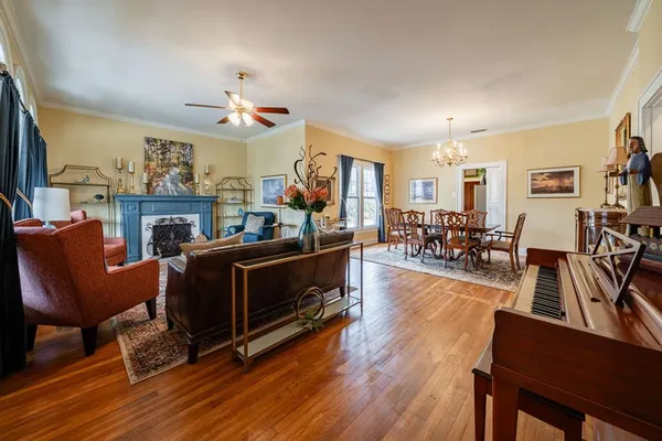 a living room with furniture a fireplace and a flat screen tv