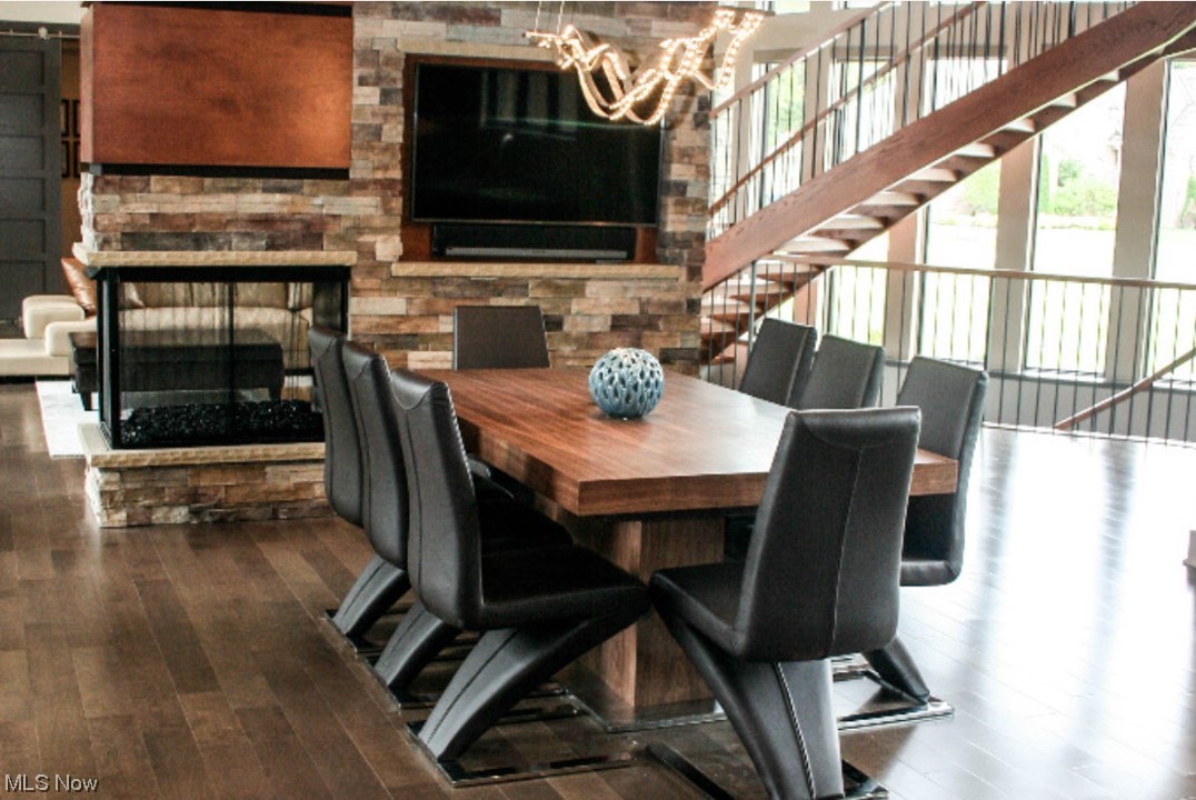 2300 Rivers Edge Drive Willoughby, OH 44094 - Photo 8 of 29 Dining area with stone two sided fireplace & hardwood flooring