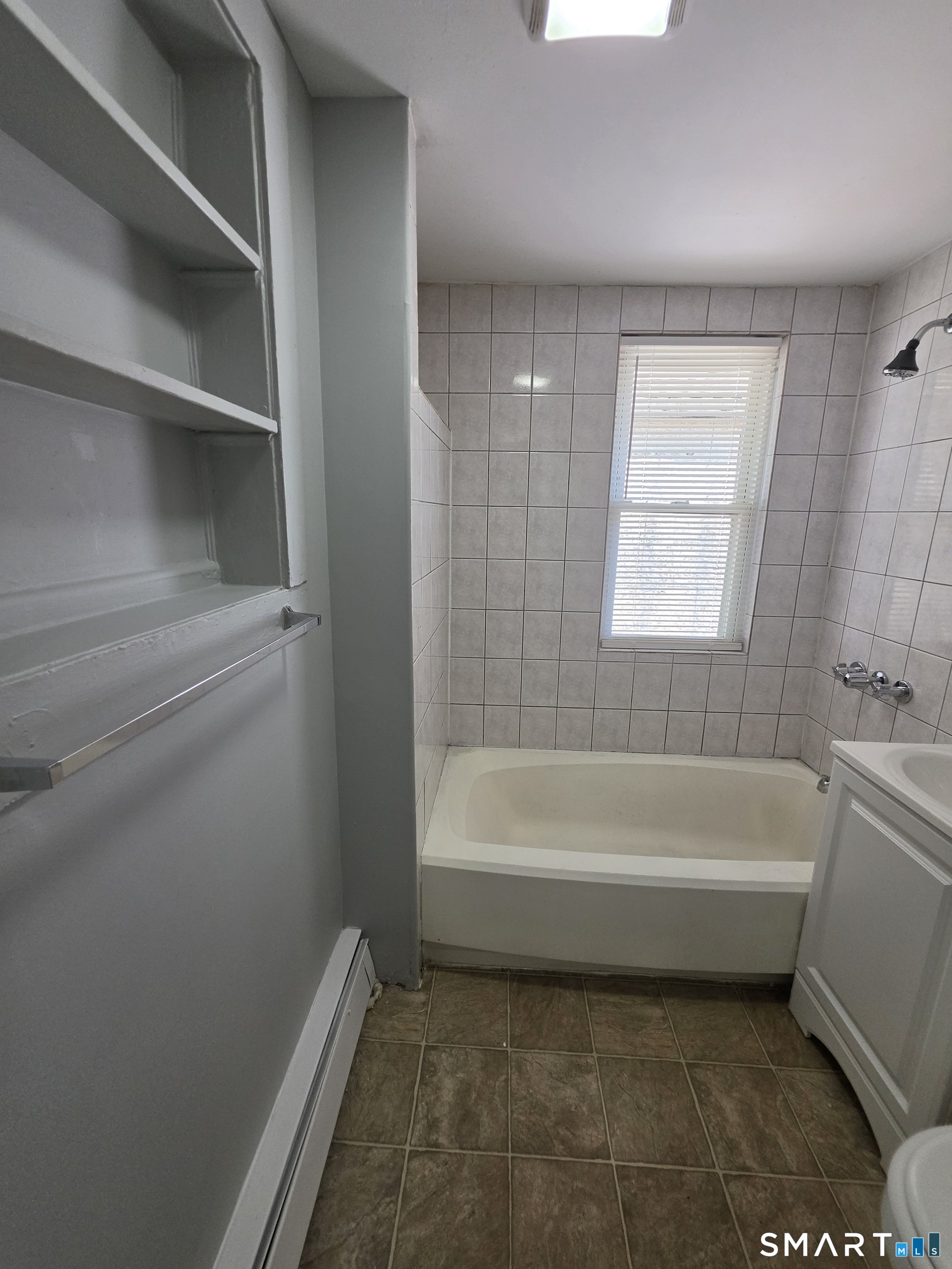 8 Mannz Street Hartford, CT 06114 - Photo 12 of 22 a bathroom with a bathtub and a shower