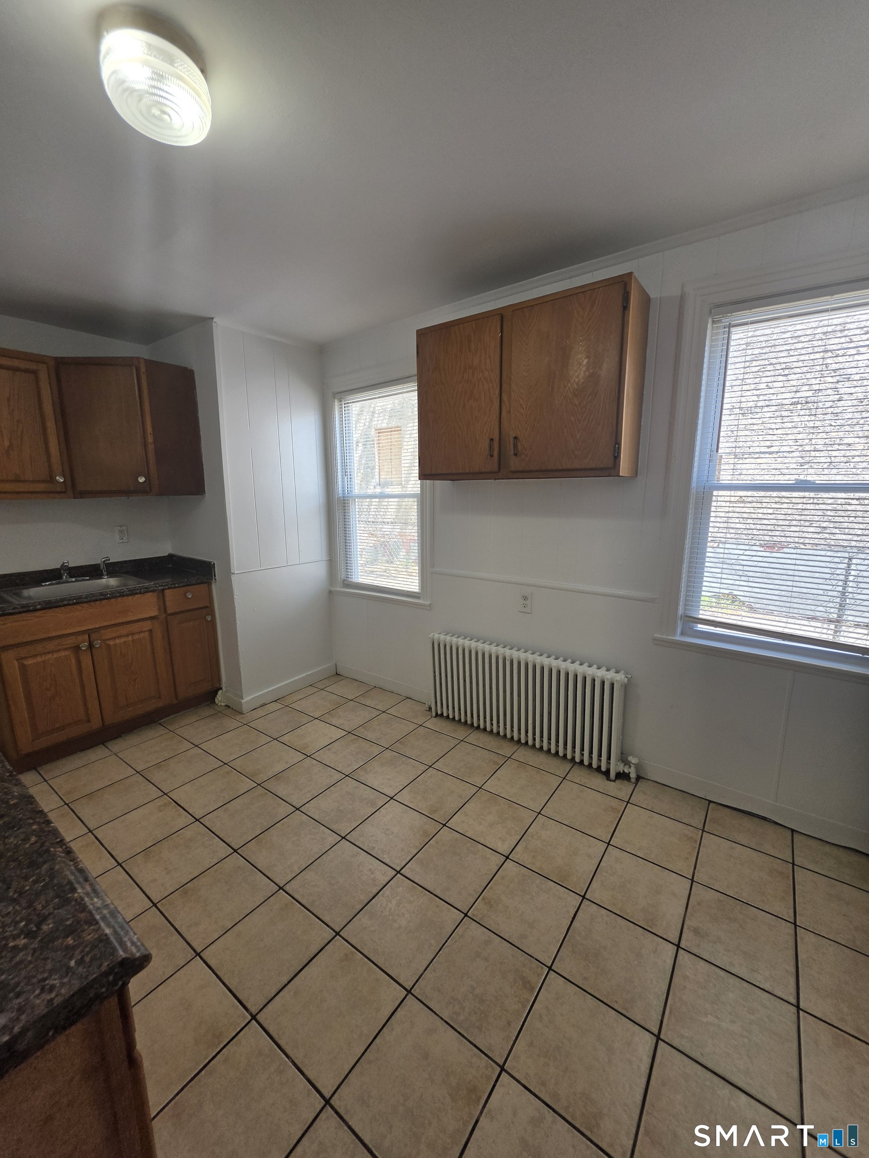 8 Mannz Street Hartford, CT 06114 - Photo 15 of 22 a bedroom with a bed and a window